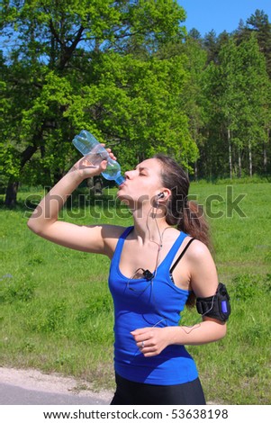 Sportive woman stop to drink a water