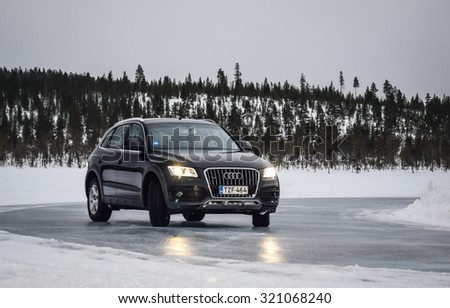 IVALO, FINLAND - February 15, 2015: Winter tire test is held at the proving ground. Test-driver performs ice handling test to determine the tire which provides the best grip on ice.