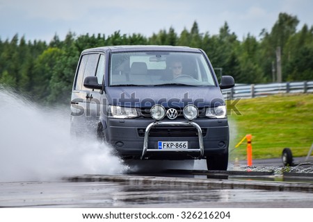 NOKIA, FINLAND - September 15, 2015: Tire test is held at the proving ground. Professional test-driver performs a longitudinal aquaplaning test.