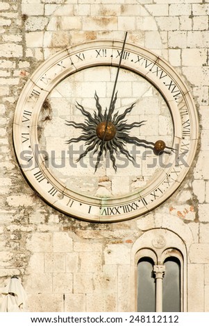 Old  clock on a stone wall