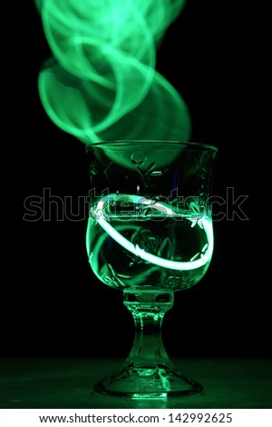 A neat party drink with an aurora glow stick.
