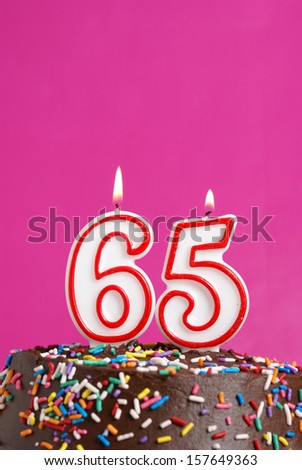 A number candle is lit in celebration of sixty five years.