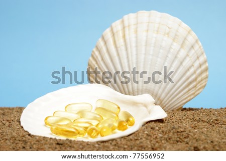 Omega three capsules in an opened seashell at the bottom of the ocean floor.