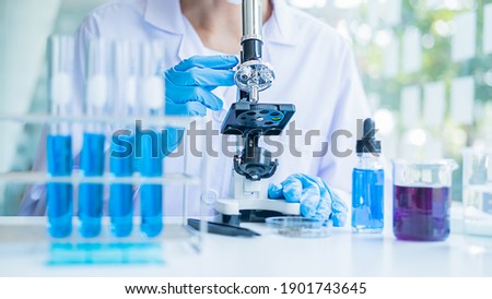 Medical or scientific researcher or man doctor looking at a test tube of clear solution in a laboratory Foto stock © 