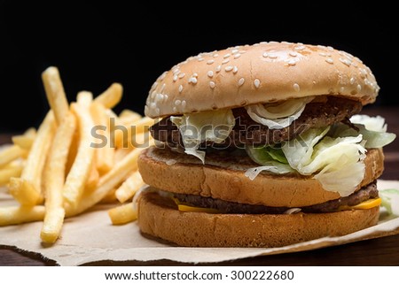 still life with fast food hamburger menu, french fries on wood desk