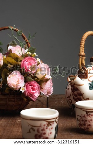 still life flower and tea pot on wood table