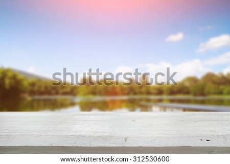 desk space and beautiful river with mountains and sun shine background for present product