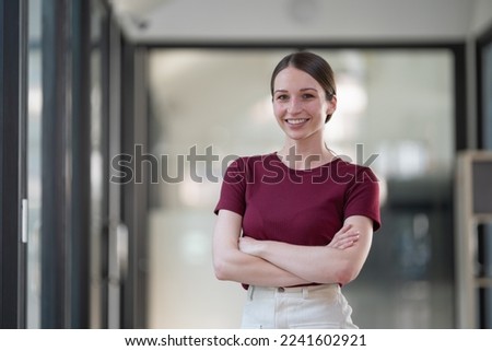Portrait of confident American businesswoman standing with arms crossed, purposeful multiracial female office employee in smart casual wear looking at the camera and smiles Foto stock © 