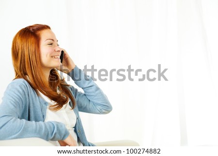 Portrait of a beautiful young woman using a cellphone and smiling