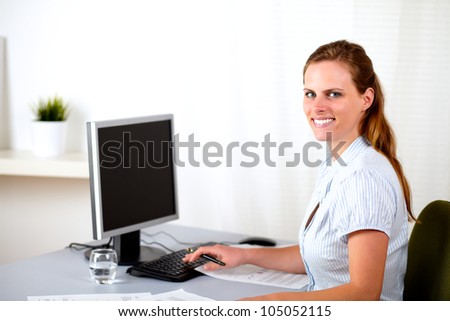 Portrait of a attractive blonde receptionist working at work desk