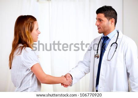Portrait of a medical specialist greeting a beautiful patient at hospital indoor