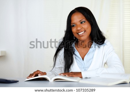 Portrait of a beautiful black woman studying at soft colors composition
