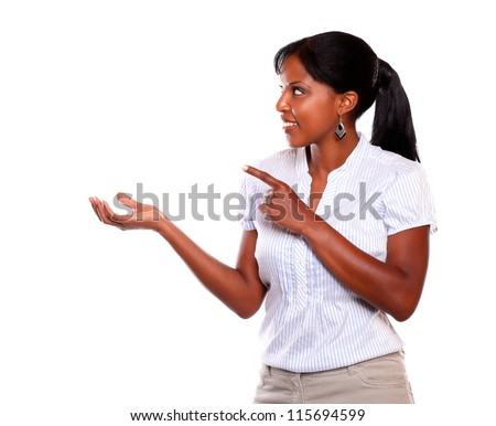 Adult woman looking and pointing to her right against white background