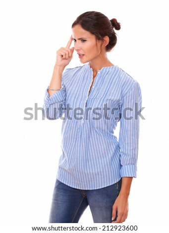 Portrait of frustrated latin woman on blue blouse wondering and looking to her right while standing on isolated white background - copyspace