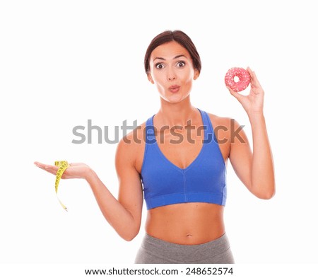 Beautiful woman in sport clothing trying to lose weight on isolated background