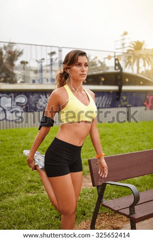 Young runner muscle stretching while exercising in summertime