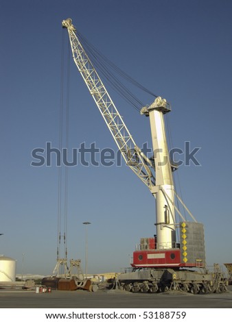 a port cranes working in the early morning hours