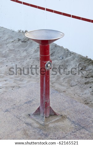 a small fountain on the beach for swimmers