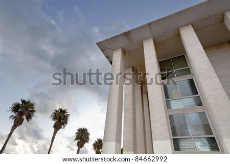 an office building surrounded by palm trees