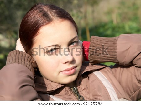 Portrait of the girl-teenager in the solar autumn afternoon
