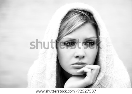 The thoughtful girl in  knitted dress black-and-white