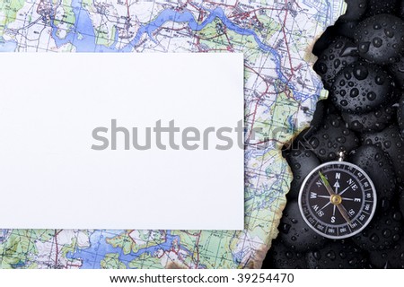 Compass with rock cover water and map