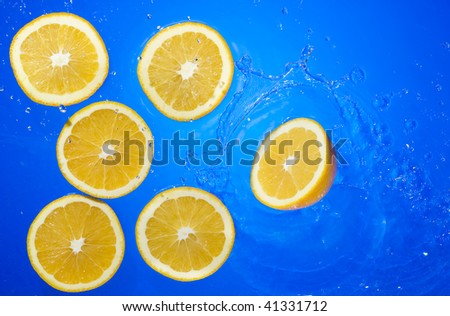 Orange with splashing water. Tropical citrus fruit