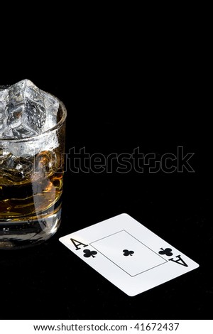 Whisky and playing card in black background. Game object