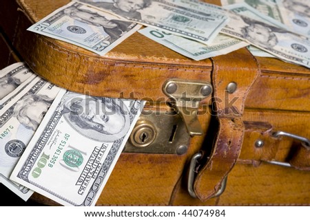 Cash ,dollar sticking out of overfilled case