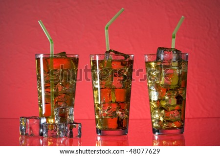 Cocktail with and ice.  Drink on red background