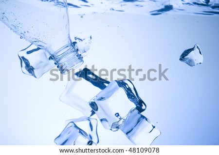 Mineral water with ice. Creative splashing blue water