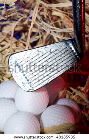 Golf club with  ball on dark background
