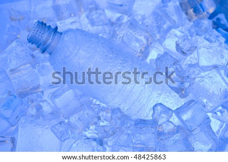 Mineral water with ice. Blue background with plastic bottle