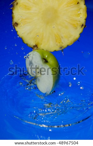 Fruit with splashing  blue water. Tropical citrus fruit