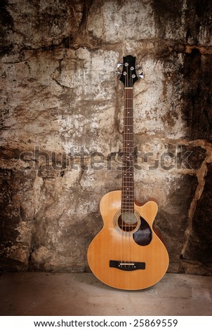 Acoustic bass guitar on wall