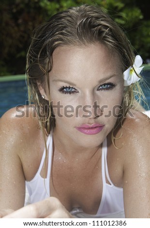 portrait of a beautiful blue eyed woman in a swimming pool