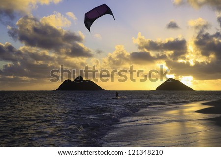 kite boarding in hawaii at daybreak