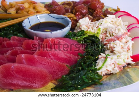Hawaiian Appetizer Plate (Polynesian Pupus) of ahi sashimi, seaweed salad,shrimp poke, ahi poke, and crab salad with soy sauce and wasabi