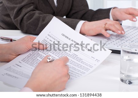 Hands of the woman signature document sitting on desk
