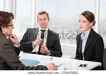 couple consults with a mature woman lawyer, signing paperwork