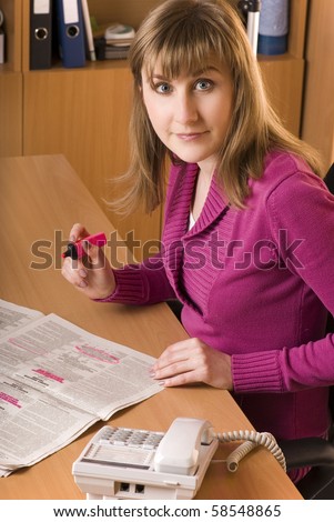 Young woman searching a job at a Newspaper Want Ad