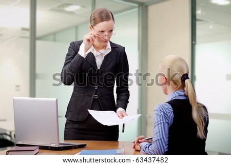 Young Lady Manager in glasses disappointed of her worker