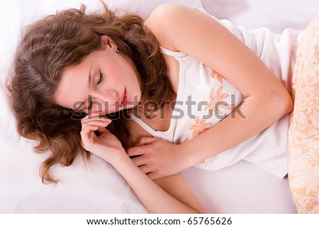 Beautiful woman (young girl) lying and sleep on the snowy bed