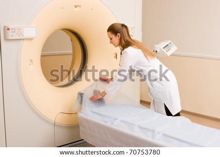 Woman Technologist preparing CT Scan Machine in hospital