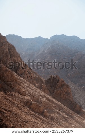 Similar – Foto Bild Felsen mit steilen Hängen in gebirgigem Terrain