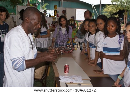 RIO DE JANEIRO - JUNE 04: staff member  showing to a unidentified  group of students how to elaborate objects of recyclable materials. Event Green Nation Fest,June 04,2012 in Rio de Janeiro,Brazil