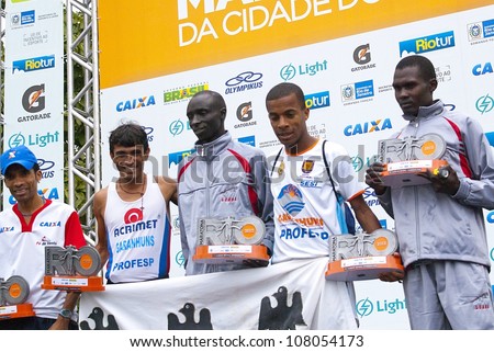 RIO DE JANEIRO-JULY8:at podium from left ot right Vianca N. Zeballos, Marcos A. Pereira, Willy C. Kmutai,Alan B. de Jesus, David K. Metto. Event Maratona do Rio,July 8,2012 at Rio de Janeiro,Brazil