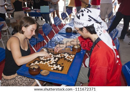 RIO DE JANEIRO - AUG 18: Japanese and Brazilian play japonese game Go at event Japanese party in Rio de Janeiro. August 18, 2012 in Rio de Janeiro, Brazil