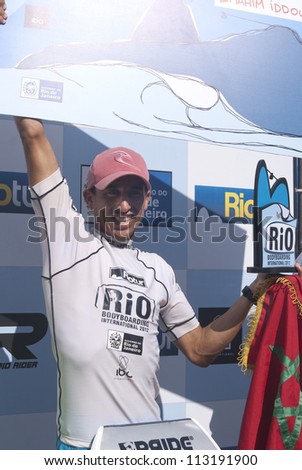 RIO DE JANEIRO - SEPT 16: Brahim Iddouch from Morocco with prizes at podium smiles after his victory in the event  2012 Rio Bodyboard International, September,16, 2012 in Rio de Janeiro, Brazil