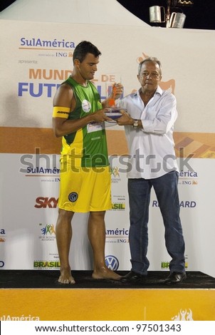 RIO DE JANEIRO - MARCH 10:Fabio of the Brasil 2 team  receiving the trophy of the best player of the Cup  at II World Cup of Futevalei Sulamerica 4x4 event March 10, 2012 in Rio de Janeiro,  Brazil